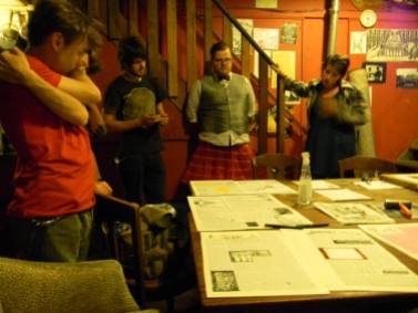 Members of the Slingshot Collective reviewing each page in a consensus meeting hours before going to print,c. 2013. (photo by Steele)